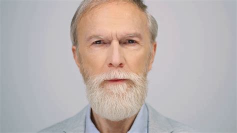 Old Man Portrait With Shocked Face Expression At Grey Background