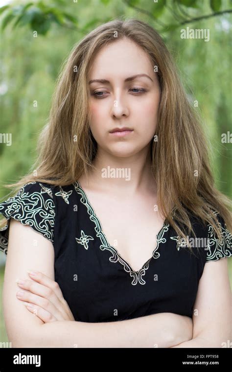 Sad Young Woman Arms Folded Looking Away Outdoors Stock Photo Alamy
