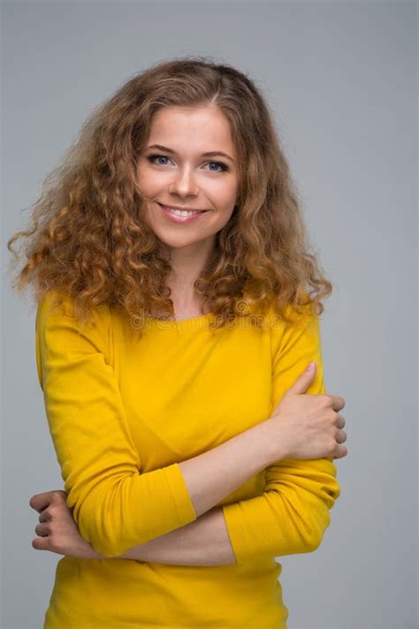 Happy Young Woman Wearing Yellow Shirt Over Grey Background Stock Photo