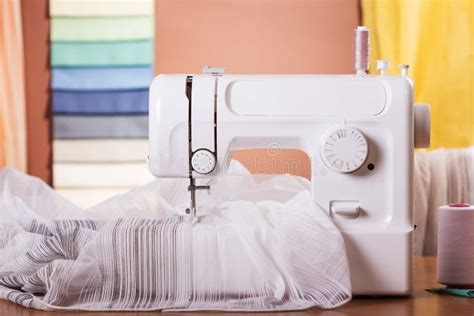 Household Sewing Machine With Spools Of Thread And Fabric Samples In