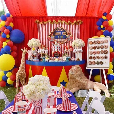A Circus Themed Birthday Party With Balloons Cupcakes And Desserts On