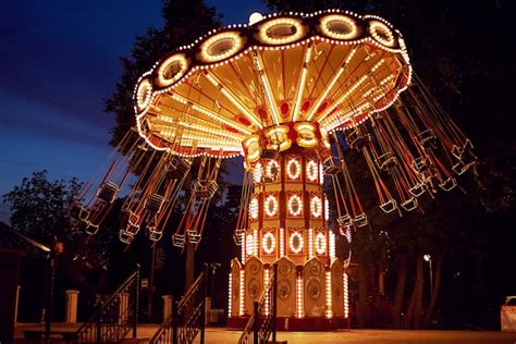 Premium Photo Illuminated Ferris Wheel In Amusement Park At Night City