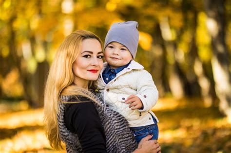 Free Photo Mom And Her Son Are In The Autumn Park The Son Loves