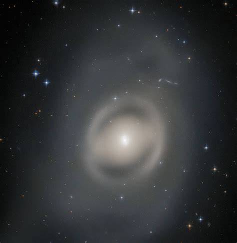 Nasas Hubble Space Telescope Captures A Lenticular Galaxy Bathing In