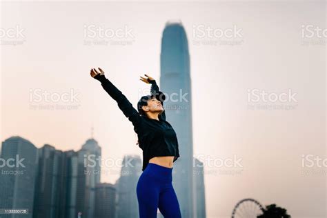 Confidence And Smiling Asian Sports Woman Stretching Arms Overhead