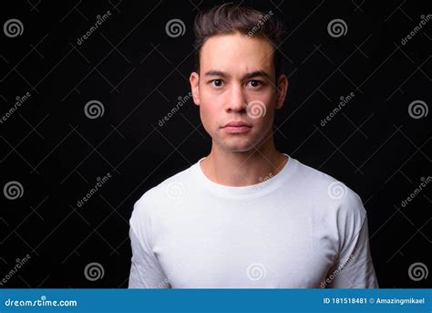 Young Handsome Multi Ethnic Man Against Black Background Stock Image