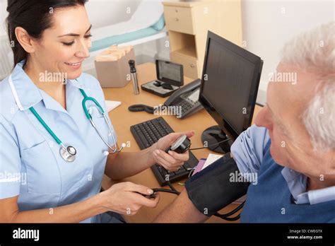 British Nurse Taking Senior Mans Blood Pressure Stock Photo Alamy