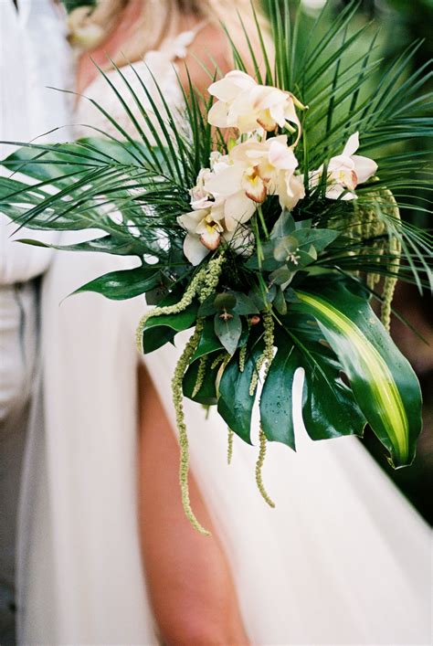 tropical bouquet tropical wedding aracna palm leaves orchids beach wedding bouquet beach
