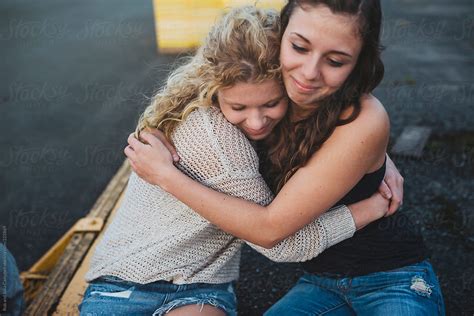 Two Pretty Teenage Girls Hugging Together Outside Saying Goodbye After Graduating By Stocksy