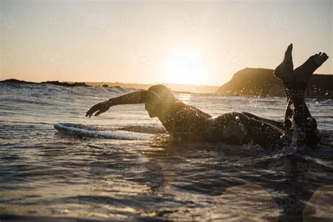 Image Of Girl Surfing In The Ocean On A Longboard During