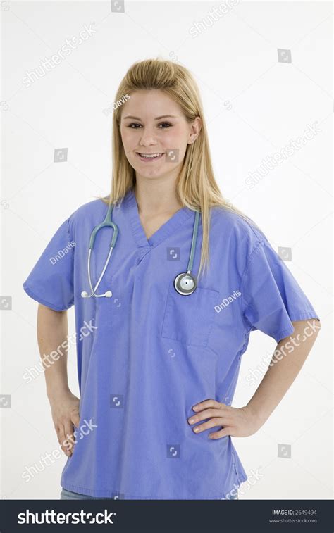 Beautiful Caucasian Female Doctor Or Nurse Wearing Scrubs Outfit And