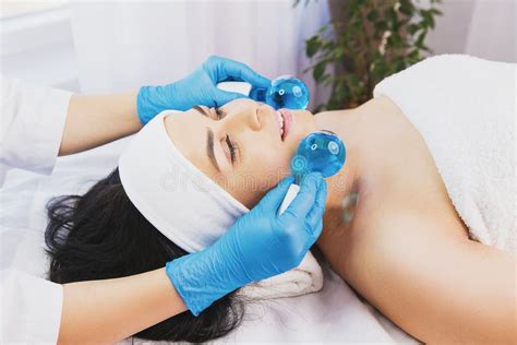 Calm Patient Woman Undergoing The Cosmetic Facial Massage Procedures For Rejuvenation Skin Face