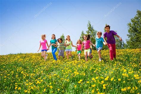 Running Children Holding Hands In Meadow — Stock Photo © Serrnovik