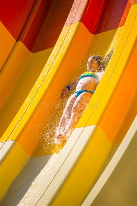 Splash Little Caucasian Girl On Water Slide Of Water Park Sunny