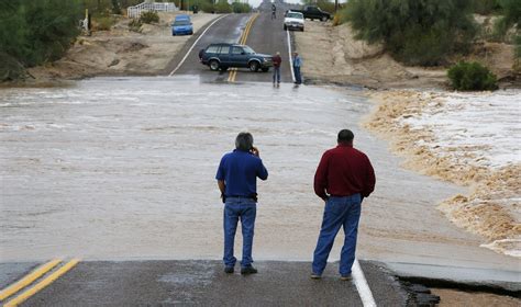 Authorities In Phoenix Rescue Woman Trapped In Car In Flood Waters