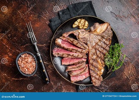 Grilled Medium Rare Porterhouse T Bone Steak Sliced In A Plate Dark Background Stock Photo