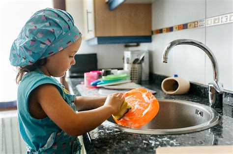 Girl Washing The Dishes