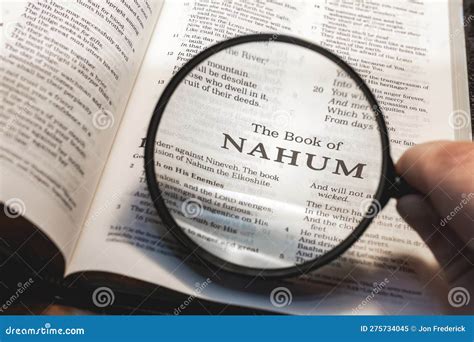 Closeup Of The Book Of Nahum From Bible Or Torah Using A Magnifying Glass To Enlarge Print