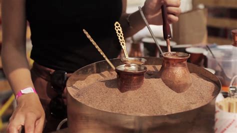 Woman Prepares Turkish Coffee On The Hot Sand Stock Video Footage