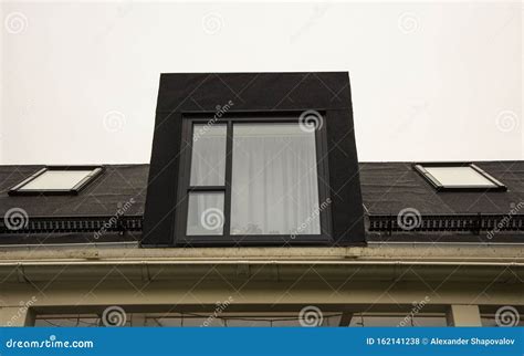 Close Up View Of Roof Window On Black Roof Of Modern Townhouse Stock