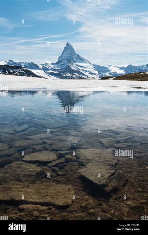 Matterhorn Mountain With Melting Frozen Lake In Summer In Zermatt