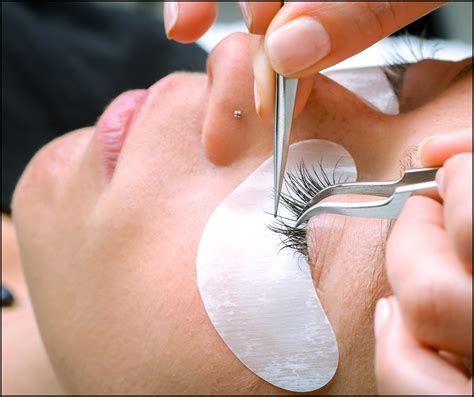 Eyelash extension procedure, woman eye with Long eyelashes - Discovery 