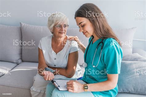 Doctor Checking Elderly Womans Blood Pressure Stock Photo Download