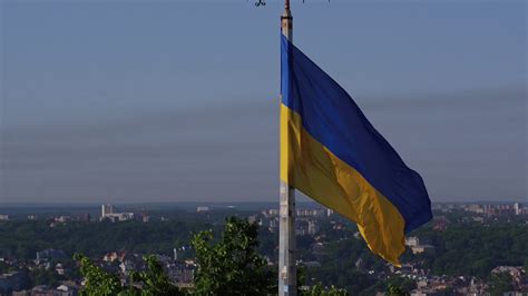 Ukrainian Flag Flying On Top Of The Beautiful Panorama Of The City Lviv
