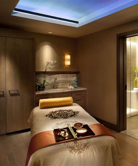 A Large Bed Sitting In A Bedroom Under A Skylight Next To A Bathroom