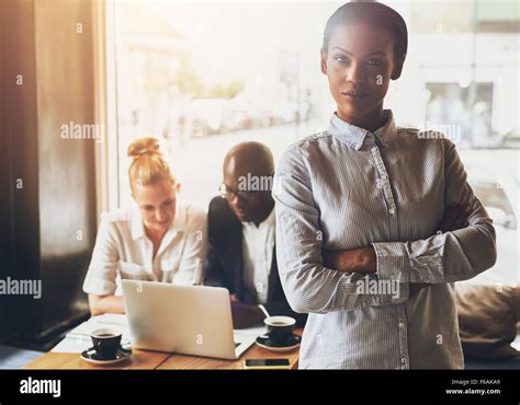 Confident Black Business Woman Standing In Front Of Colleagues Stock