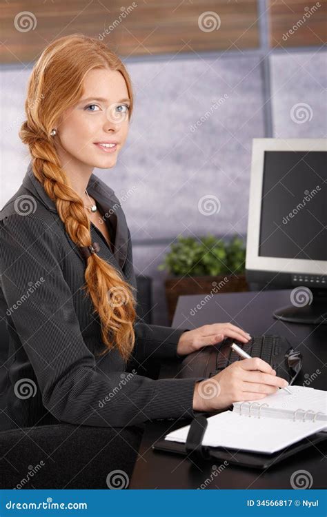Attractive Redhead Businesswoman At Work Stock Image 34566817