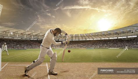 Side View Of Batsman Defending Ball During Match At Stadium — Sports