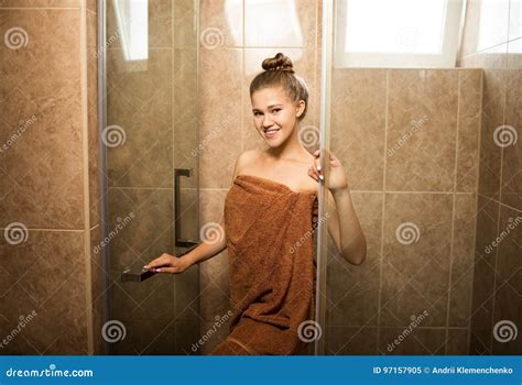Sexy Young Girl Takes A Shower In The Bathroom On A Brown Tile Background The Attractive Woman