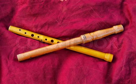 Two Wooden Old Flutes On A Rough Red Fabric Stock Image Colourbox