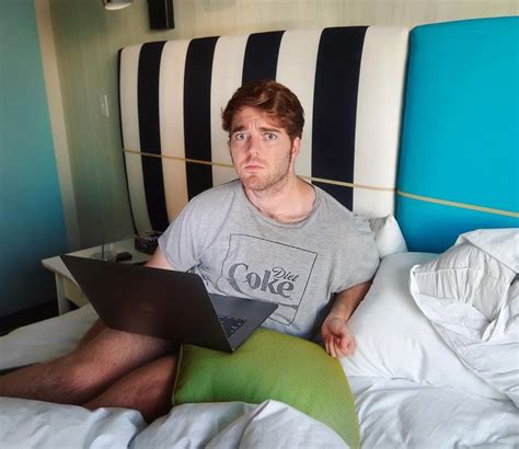 A Man Sitting In Bed With A Laptop