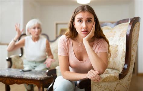 domestic quarrel between elderly mother and adult daughter in living room stock image image of