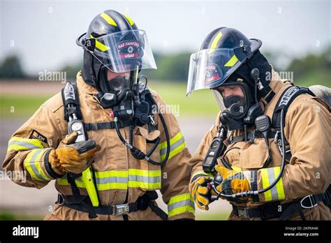Firefighters From The 422d Fire Emergency Services Check Their Oxygen Levels During A Live Fire