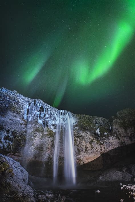 Iceland Portrait Of A Green Aurora Display Above Seljalandsfoss