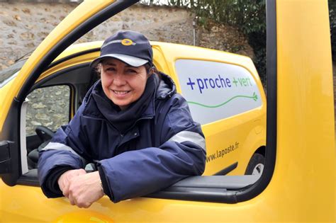 A Smiling Woman Leaning Out The Window Of A Yellow Truck With Her Hand