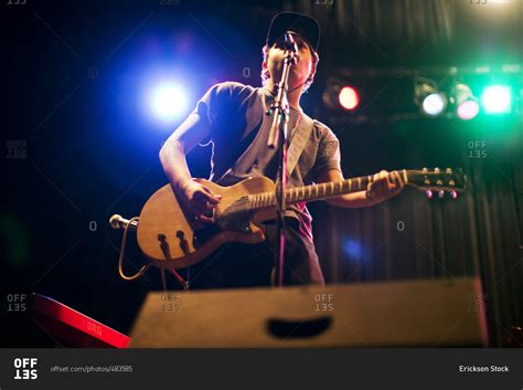 Teenage Boy Singing And Playing Guitar On Stage Stock Photo Offset