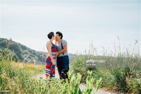 Pregnant Lesbian Couple Kissing On Path Photo Getty Images