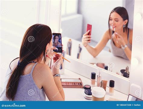 Beauty Blogger Filming Makeup Tutorial With Smartphone In Front Of