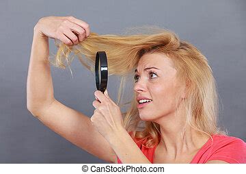 Woman Looking At Hair Through Magnifying Glass Haircare And