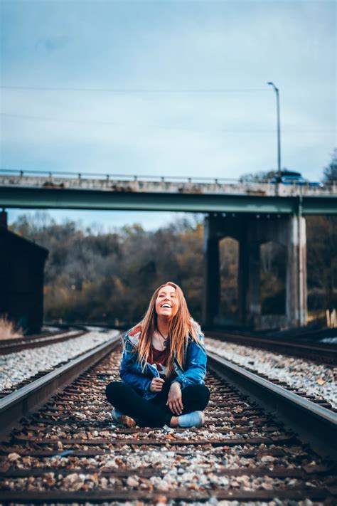 Smiling Woman Sitting On Train Railway Photo Free Rail Image On Unsplash Railroad Photoshoot