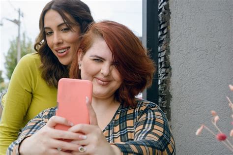 Premium Photo Front View Of Two Beautiful Latin Women Taking A Selfie With The Phone