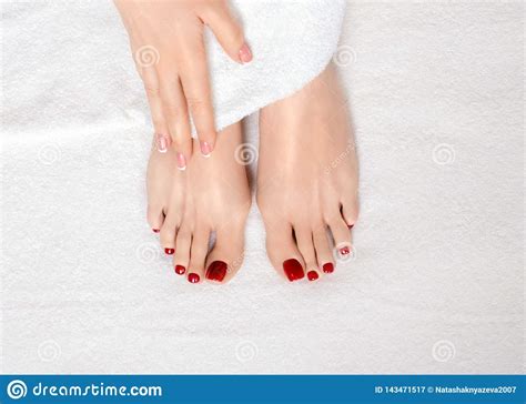 Classic Red Pedicure Treatment Female Feet And Hand On White Terry
