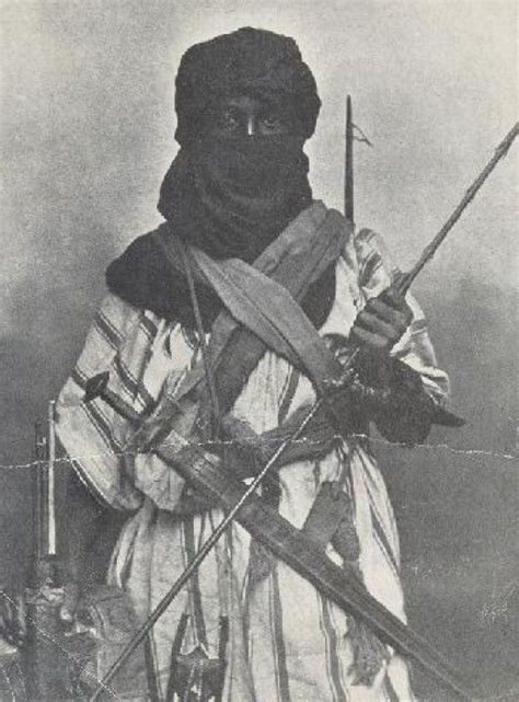 An Old Black And White Photo Of A Woman Holding Two Swords In One Hand