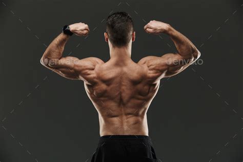 Back View Of A Muscular Bodybuilder Flexing Biceps Stock Photo By