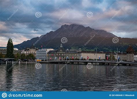 View From The Lake Of Rows Of Buildings And Flags On The Shore In Lucerne Switzerland Stock