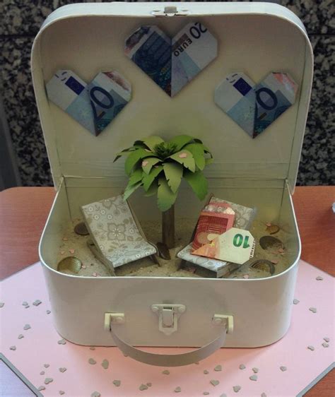 An Open Suitcase With Money And A Small Tree In It On Top Of A Table